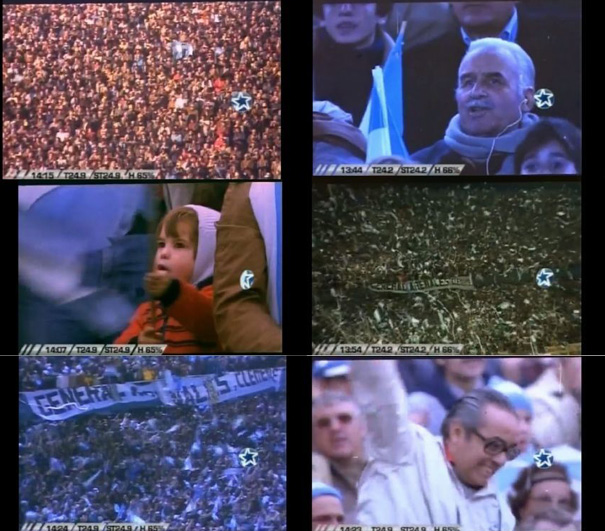 Multitud de personas en un evento al aire libre con algunas ondeando banderas y mostrando entusiasmo, incluyendo un niño y un adulto mayor entre la multitud.

Description generated by AI